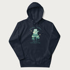 Navy blue hoodie with a graphic of a frog playing a banjo on a mushroom under the moon and stars, with the text 'Don't Worry, Everything's Gonna Be Just Fine.'