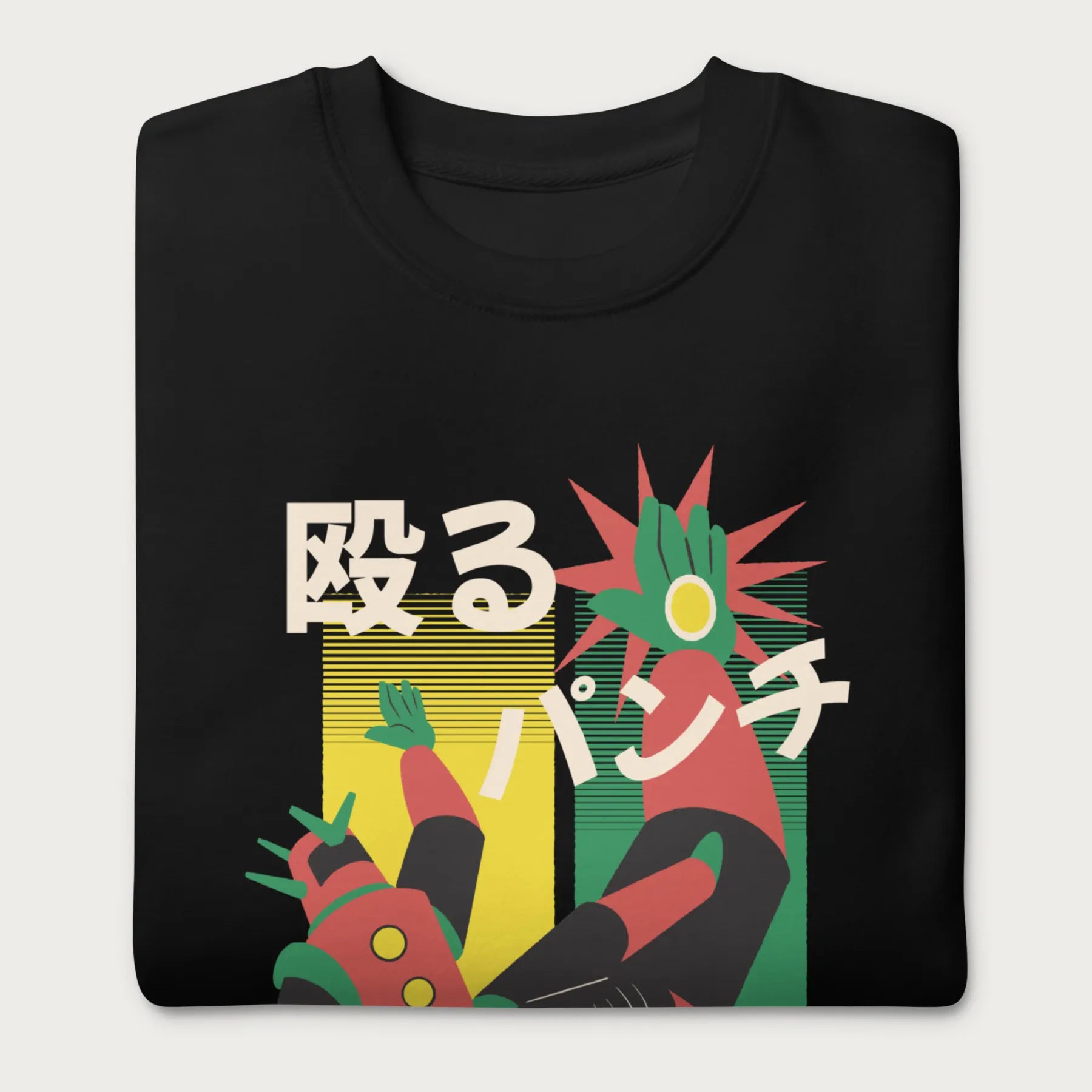 Folded black sweatshirt with Japanese text and a retro mecha punch graphic.