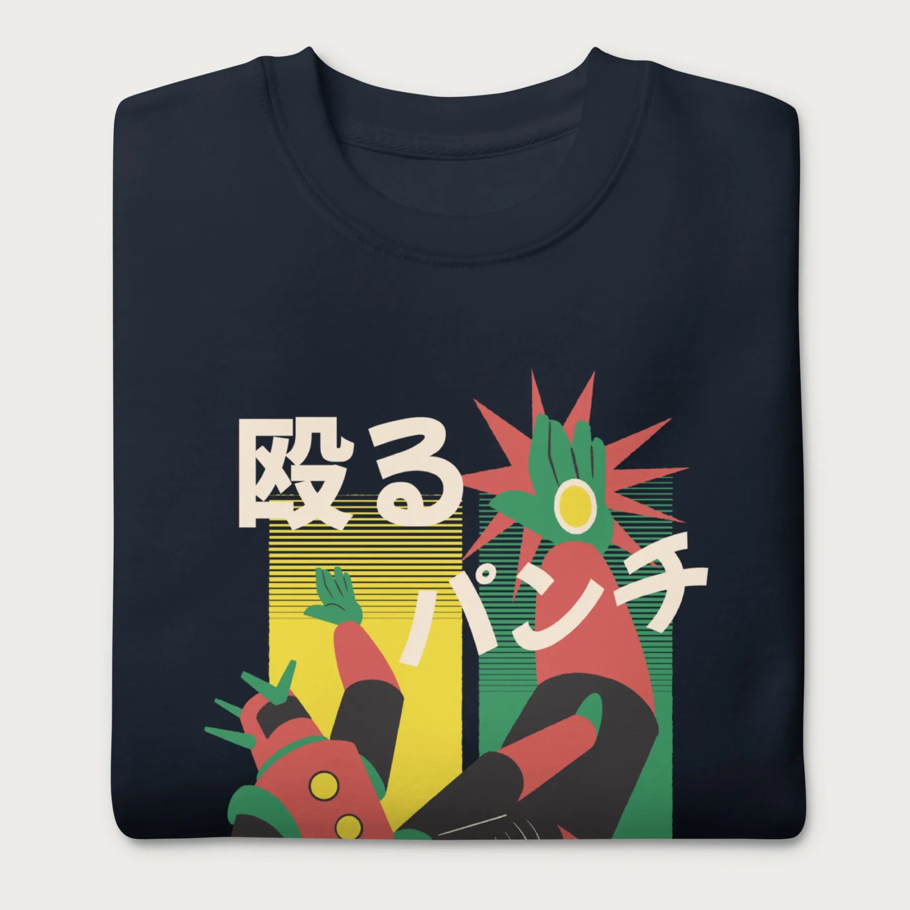 Folded navy blue sweatshirt with Japanese text and a retro mecha punch graphic.