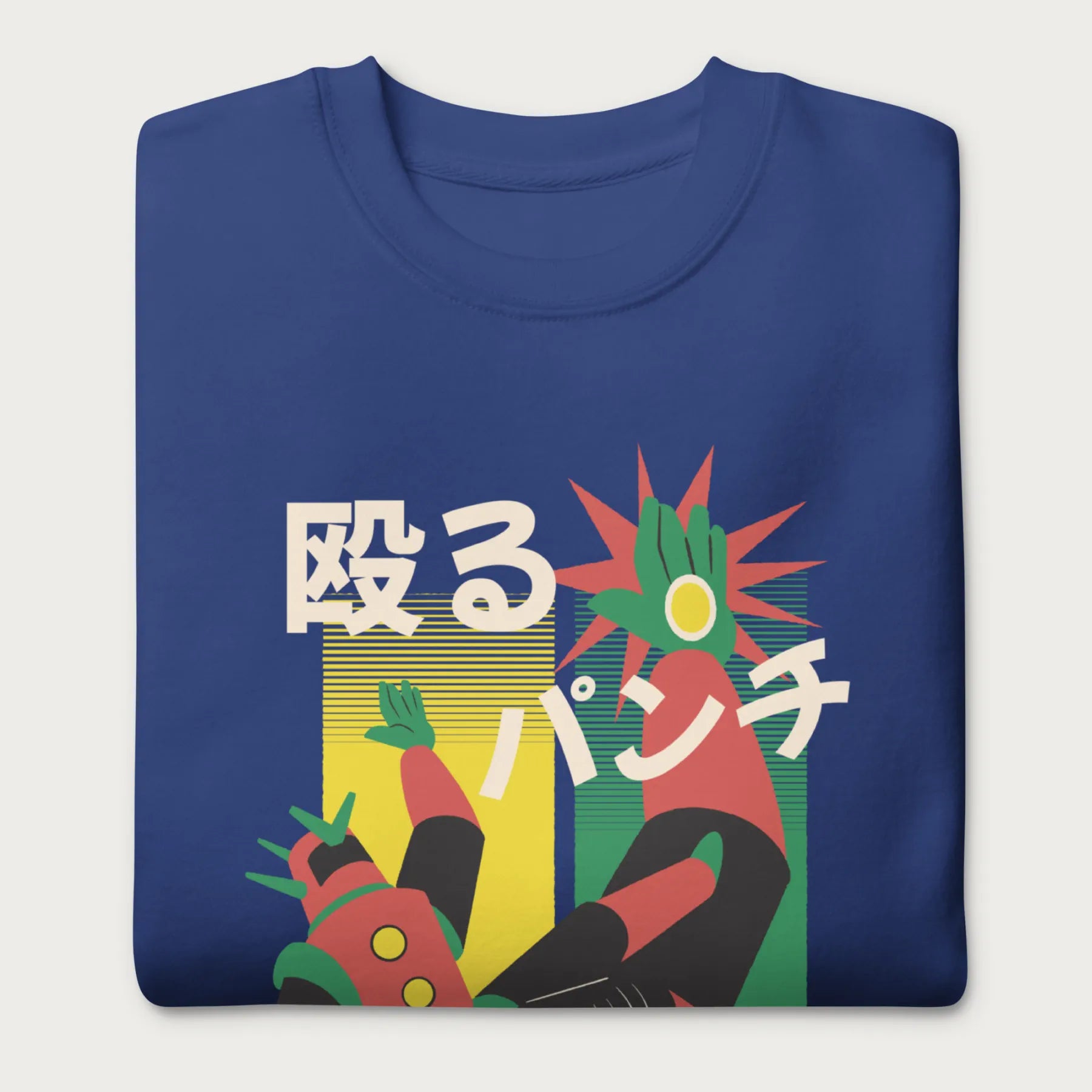 Folded royal blue sweatshirt with Japanese text and a retro mecha punch graphic.