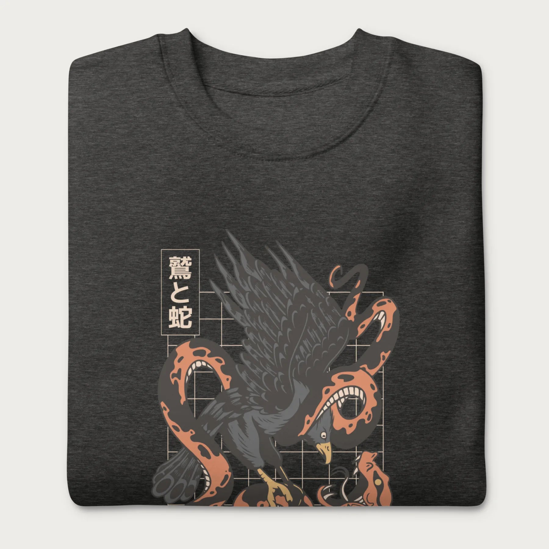 Folded dark grey sweatshirt with Japanese text and a graphic of an eagle and a snake in combat.