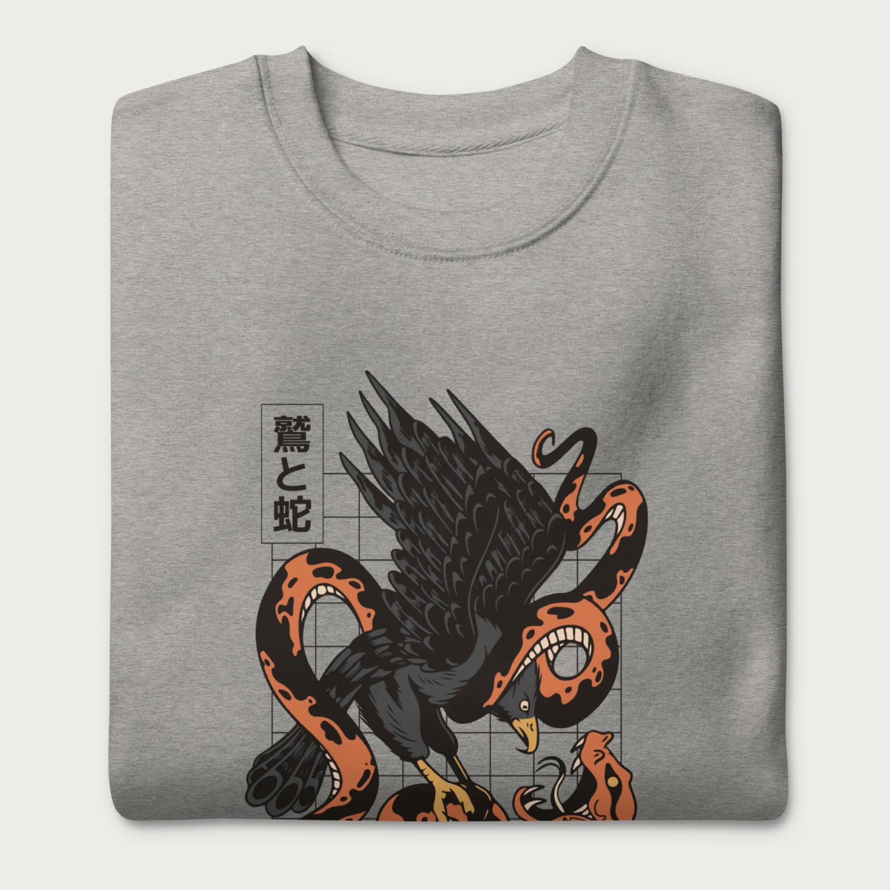 Folded light grey sweatshirt with Japanese text and a graphic of an eagle and a snake in combat.