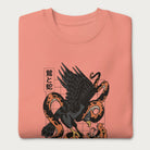 Folded light pink sweatshirt with Japanese text and a graphic of an eagle and a snake in combat.