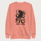 Light pink sweatshirt with Japanese text and a graphic of an eagle and a snake in combat.