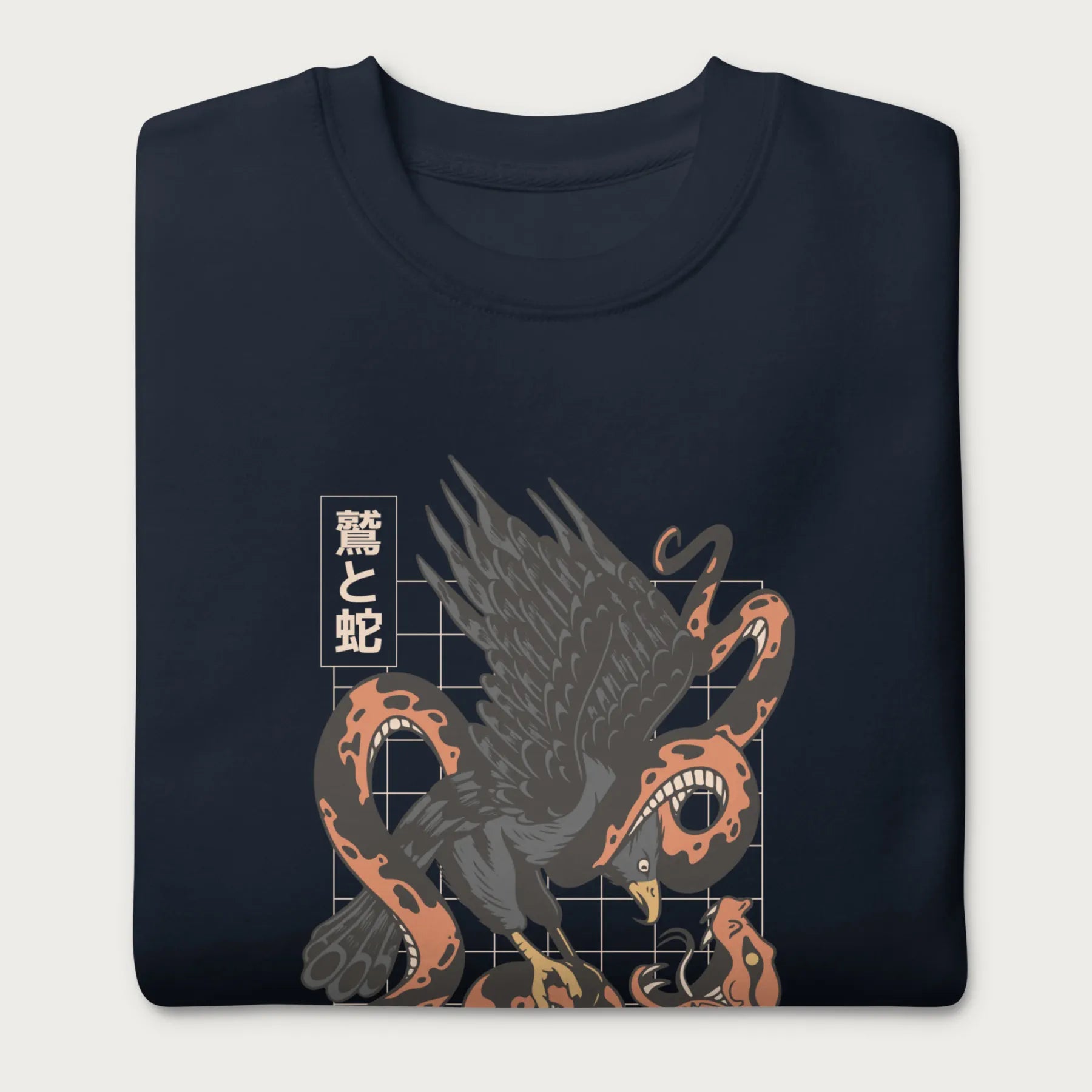 Folded navy blue sweatshirt with Japanese text and a graphic of an eagle and a snake in combat.