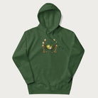 Forest green hoodie with a graphic of a frog lounging in a hammock between tall mushrooms.