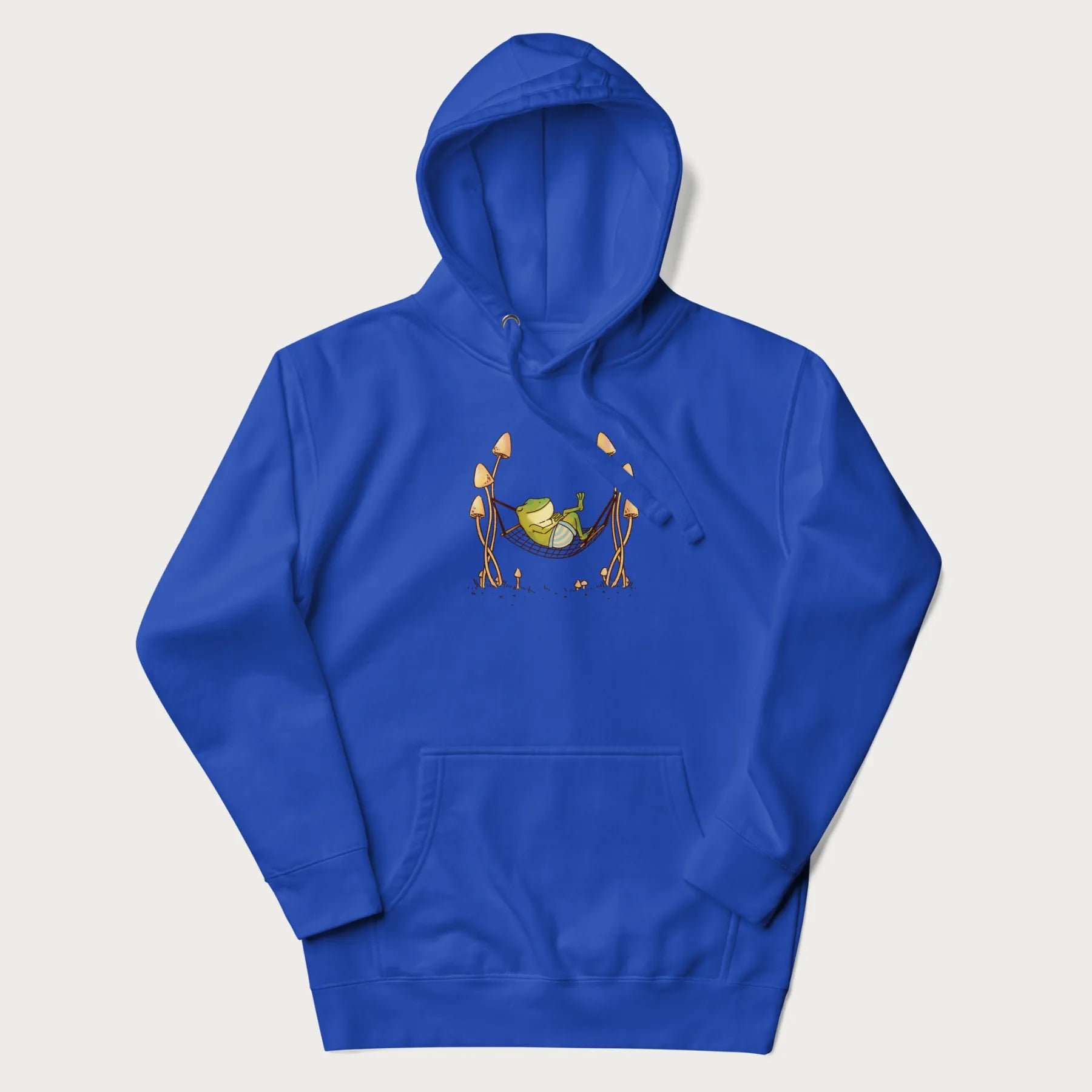 Royal blue hoodie with a graphic of a frog lounging in a hammock between tall mushrooms.