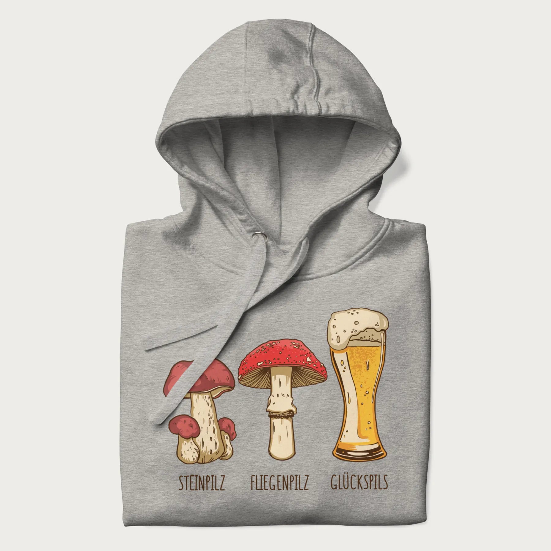 Folded light grey hoodie with illustrations of a Steinpilz, Fliegenpilz, and a beer glass labeled Glückspils.