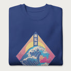 Folded royal blue sweatshirt with a graphic of the Japanese Great Wave, a retro sun, and Japanese text.