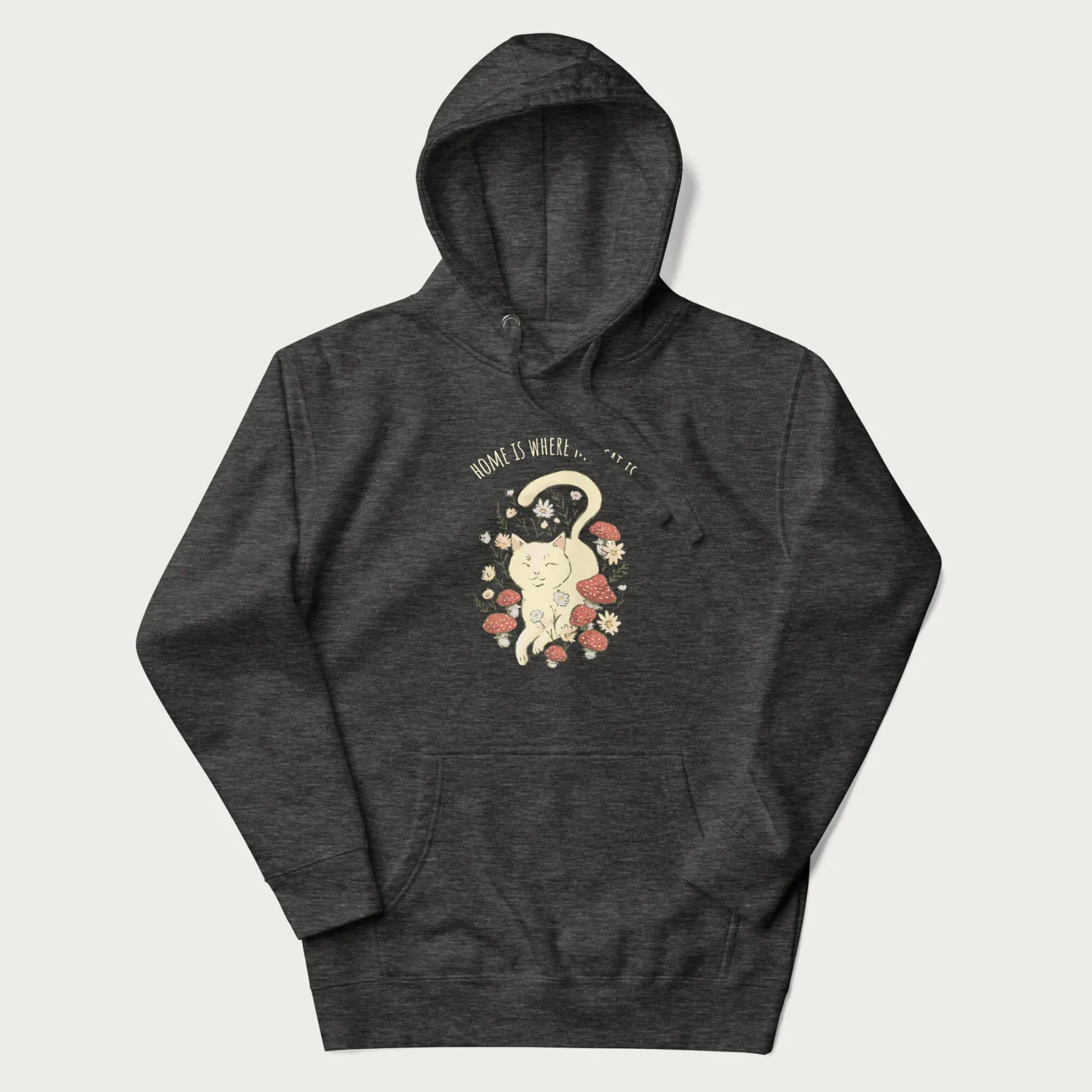 Dark grey hoodie with a graphic of a cat nestled among flowers and mushrooms with the text 'Home is Where My Cat Is' above.