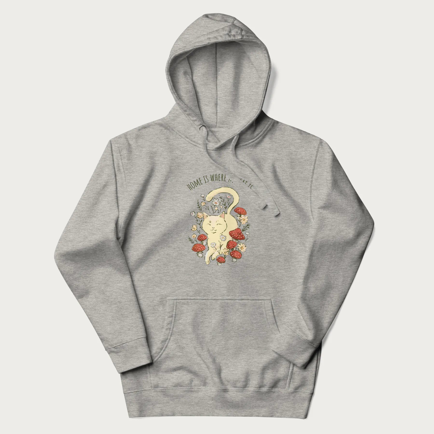 Light grey hoodie with a graphic of a cat nestled among flowers and mushrooms with the text 'Home is Where My Cat Is' above.