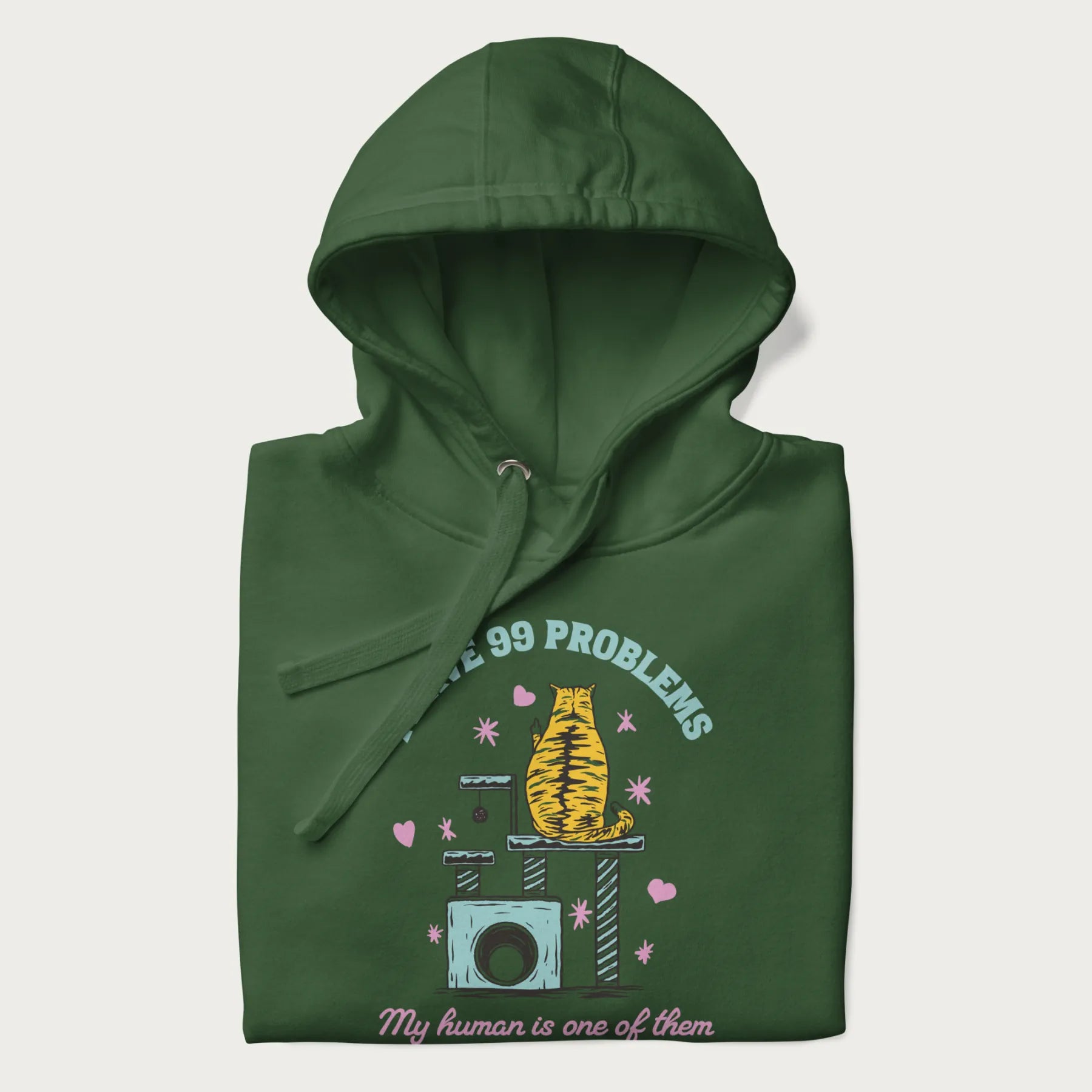 Folded forest green hoodie with graphic of a cat on a scratching post and text 'i have 99 problems, my human is one of them'.