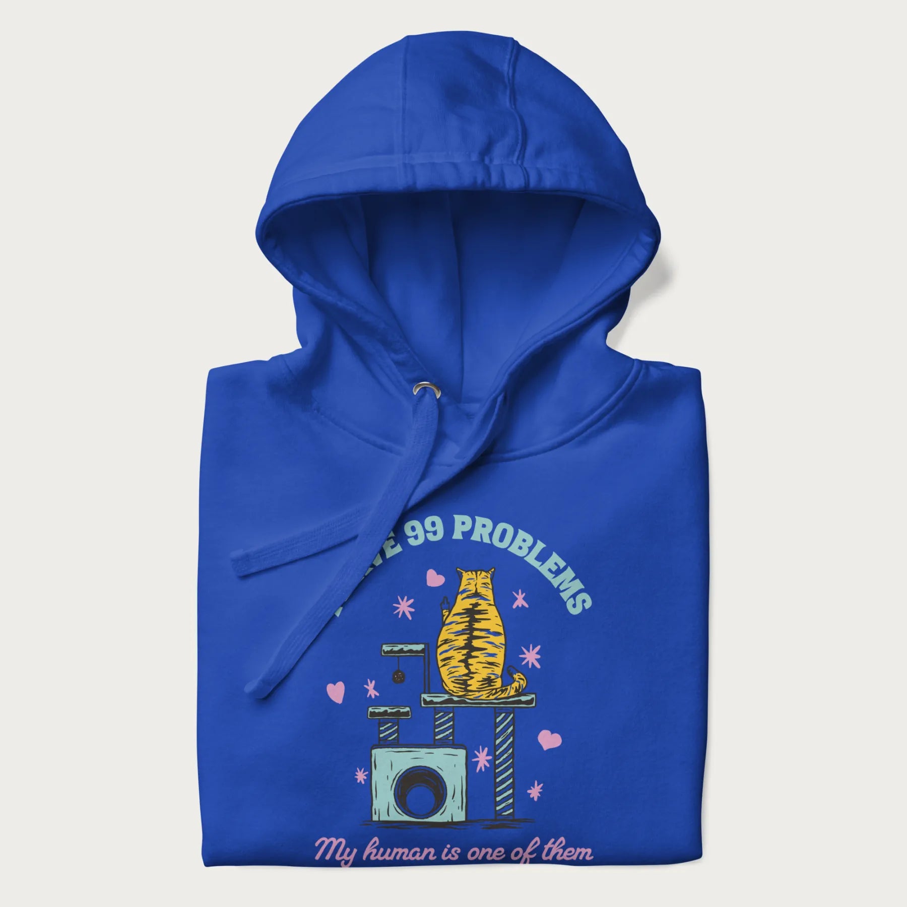 Folded royal blue hoodie with graphic of a cat on a scratching post and text 'i have 99 problems, my human is one of them'.