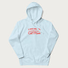 Graphic on a light blue hoodie saying 'I Just Wanna Be a Cat Mom' with pink lettering and paw prints.