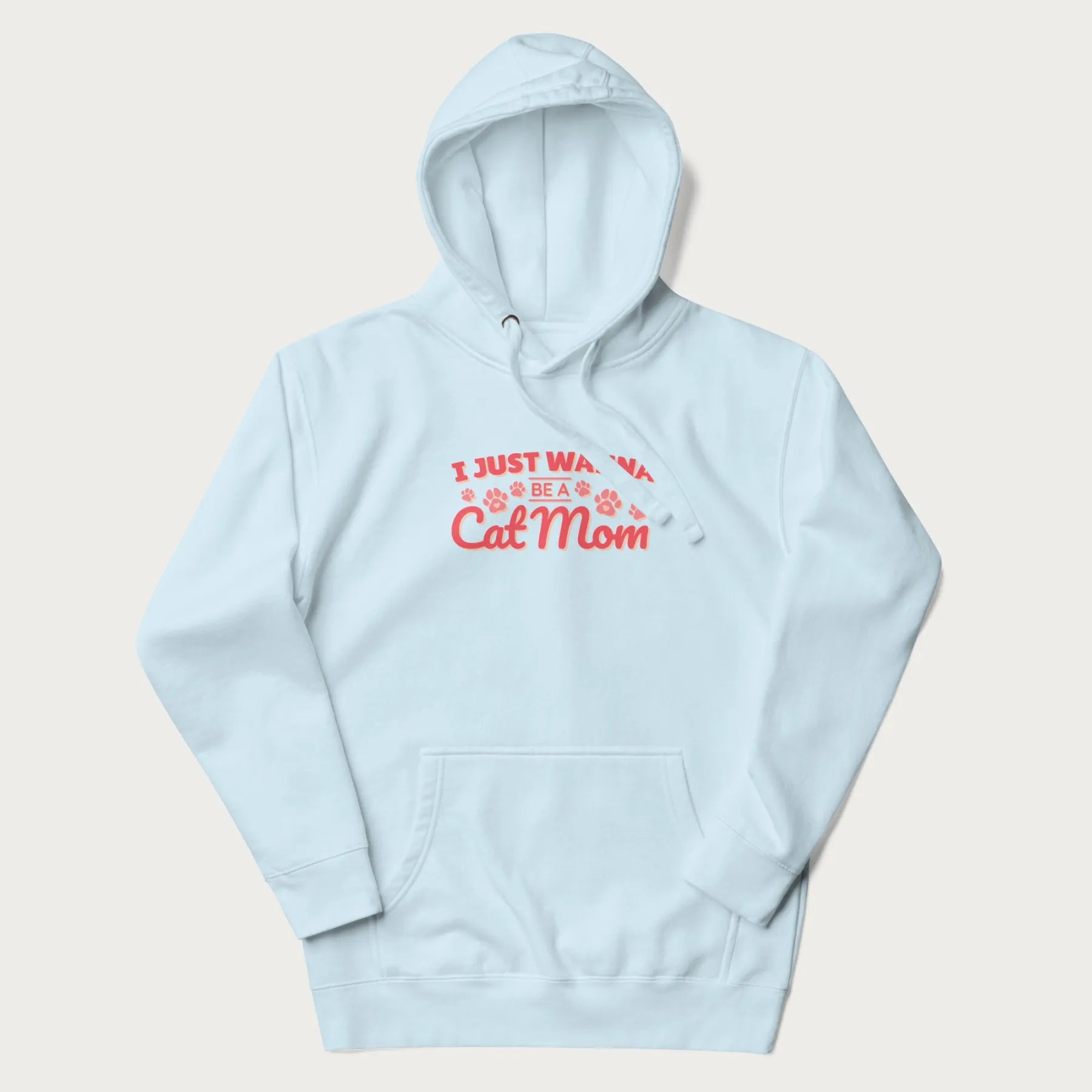 Graphic on a light blue hoodie saying 'I Just Wanna Be a Cat Mom' with pink lettering and paw prints.