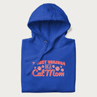 Graphic on a folded royal blue hoodie saying 'I Just Wanna Be a Cat Mom' with pink lettering and paw prints.