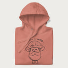 Folded light pink hoodie with graphic of a cute mushroom with heart-shaped eyes and the text "I Love You So Mush."