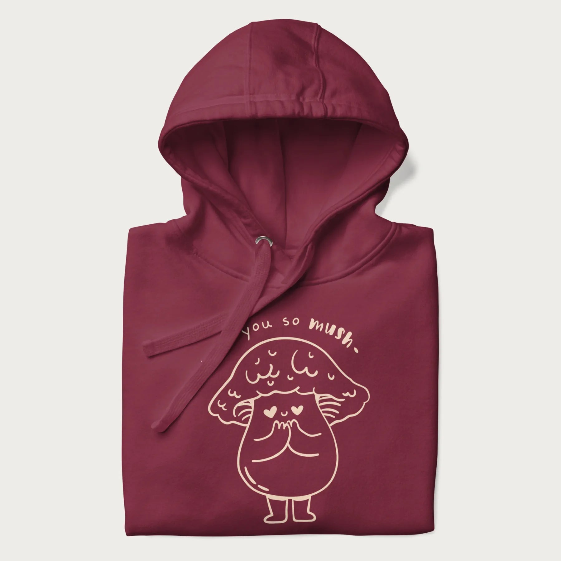 Folded maroon hoodie with graphic of a cute mushroom with heart-shaped eyes and the text "I Love You So Mush."