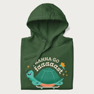 Folded forest green hoodie with a graphic of a happy turtle on a skateboard and the text 'I Wanna Go Faaaaast'.