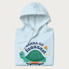 Folded light blue hoodie with a graphic of a happy turtle on a skateboard and the text 'I Wanna Go Faaaaast'.