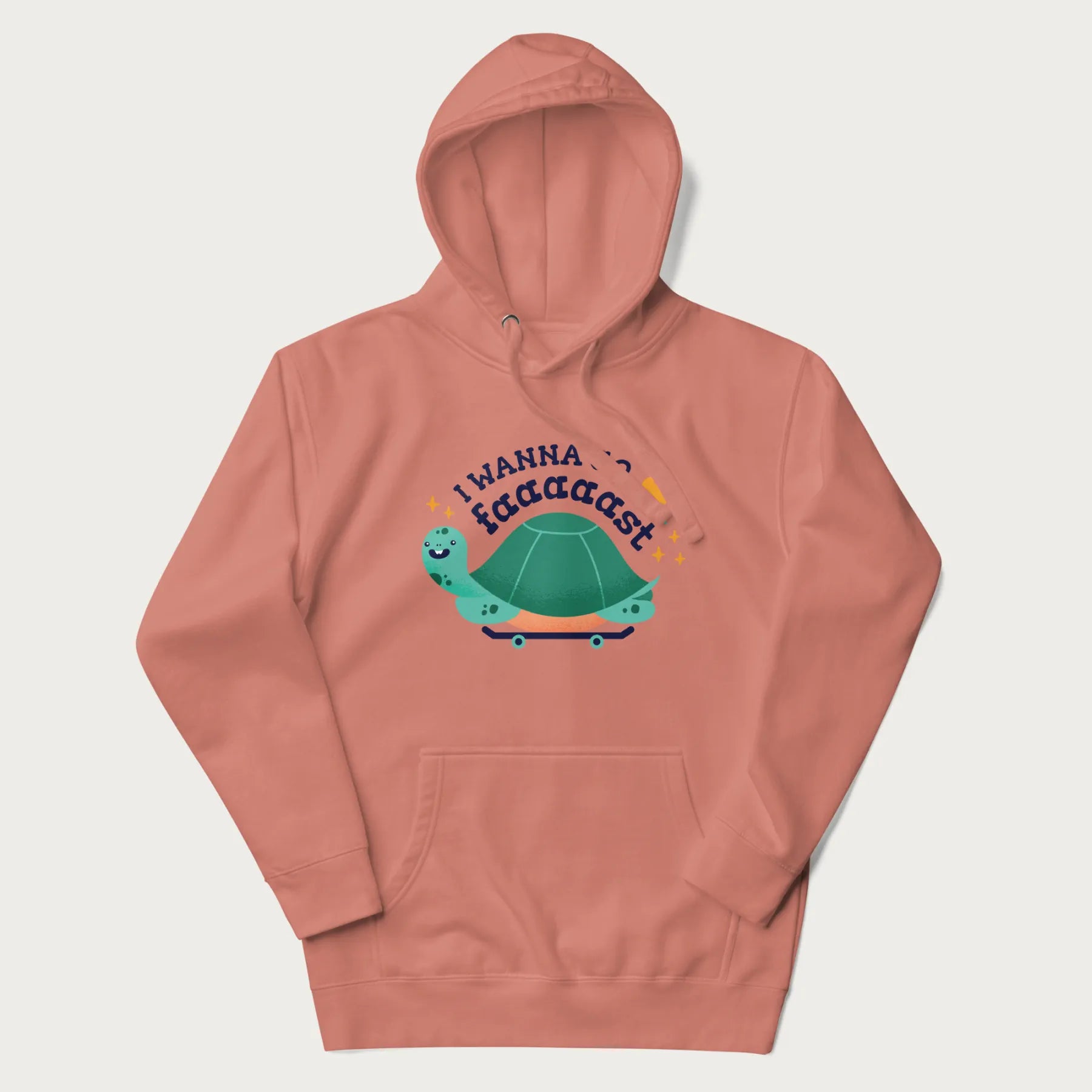 Light pink hoodie with a graphic of a happy turtle on a skateboard and the text 'I Wanna Go Faaaaast'.