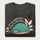 Folded dark grey sweatshirt with a graphic of a turtle hiding in its shell and the phrase 'If You Need Me, I'll Be in My Shell.'