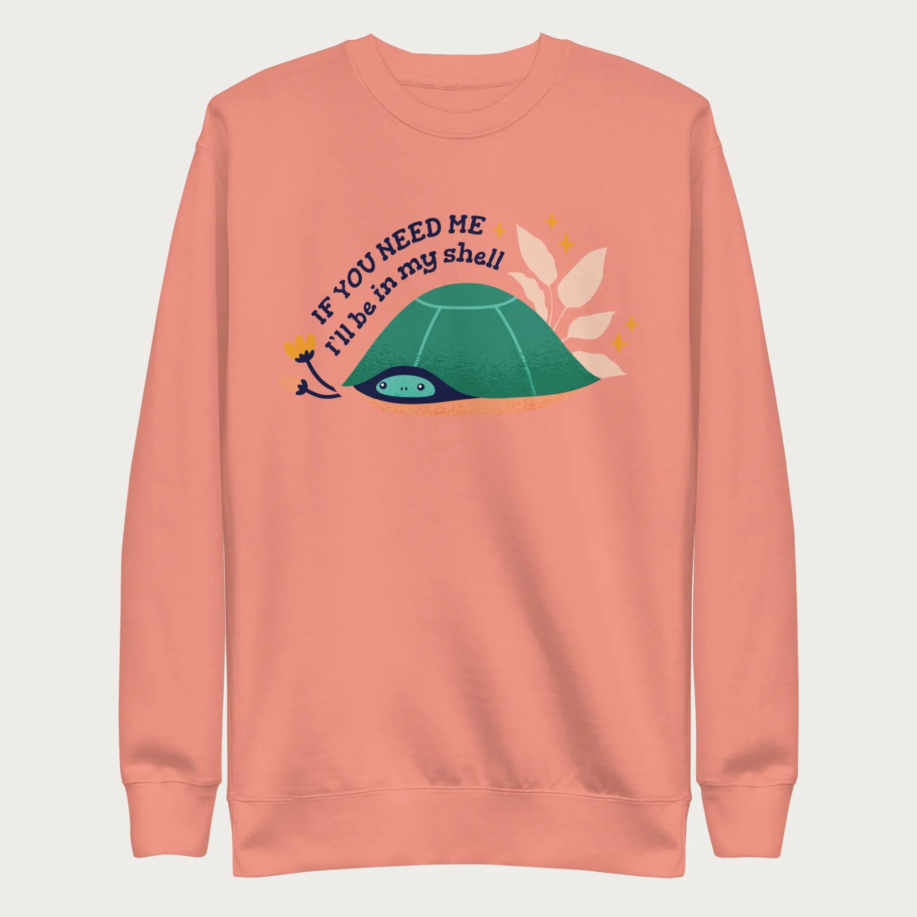 Light pink sweatshirt with a graphic of a turtle hiding in its shell and the phrase 'If You Need Me, I'll Be in My Shell.'