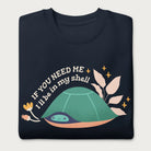 Folded navy blue sweatshirt with a graphic of a turtle hiding in its shell and the phrase 'If You Need Me, I'll Be in My Shell.'