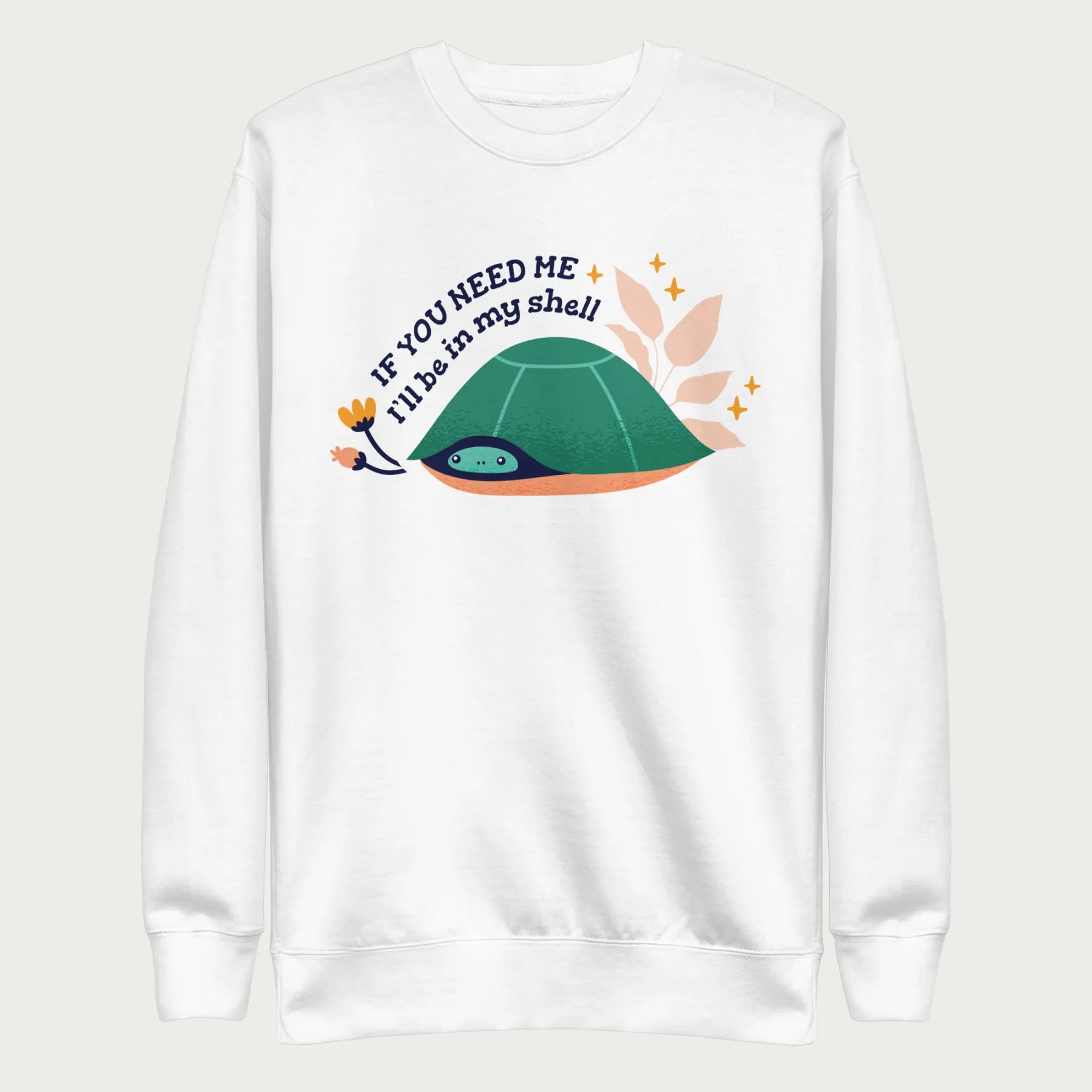 White sweatshirt with a graphic of a turtle hiding in its shell and the phrase 'If You Need Me, I'll Be in My Shell.'