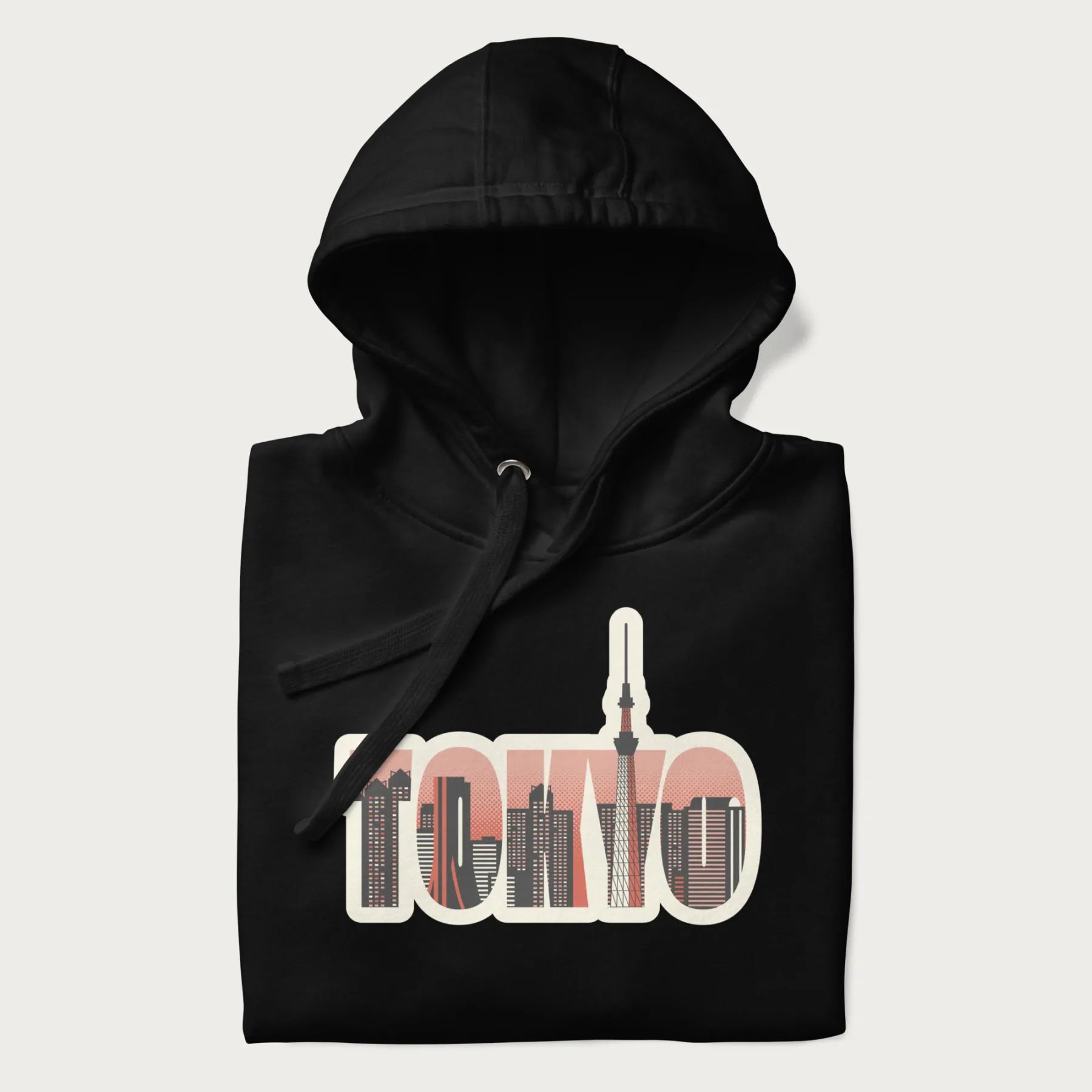 Folded black hoodie with graphic of Tokyo's skyline integrated into the word 'TOKYO' in sunset colors.