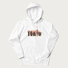 White hoodie with graphic of Tokyo's skyline integrated into the word 'TOKYO' in sunset colors.