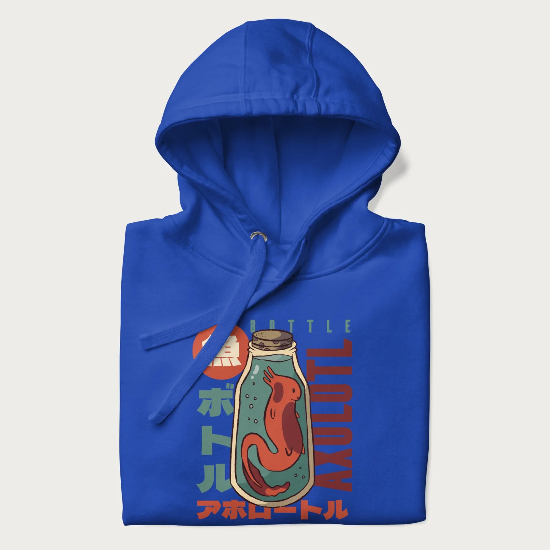 Folded royal blue hoodie with Japanese graphic of a red axolotl in a bottle with Japanese text 'ボトル' (Bottle) and 'アホロートル' (Axolotl).