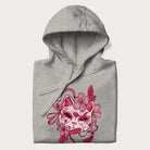 Folded light grey hoodie with a Japanese kitsune mask and sakura design on the front.