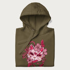 Folded military green hoodie with a Japanese kitsune mask and sakura design on the front.