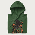 Folded forest green hoodie with Japanese text and a graphic of an eagle battling a snake, with the text 'Tokyo Japan' underneath.