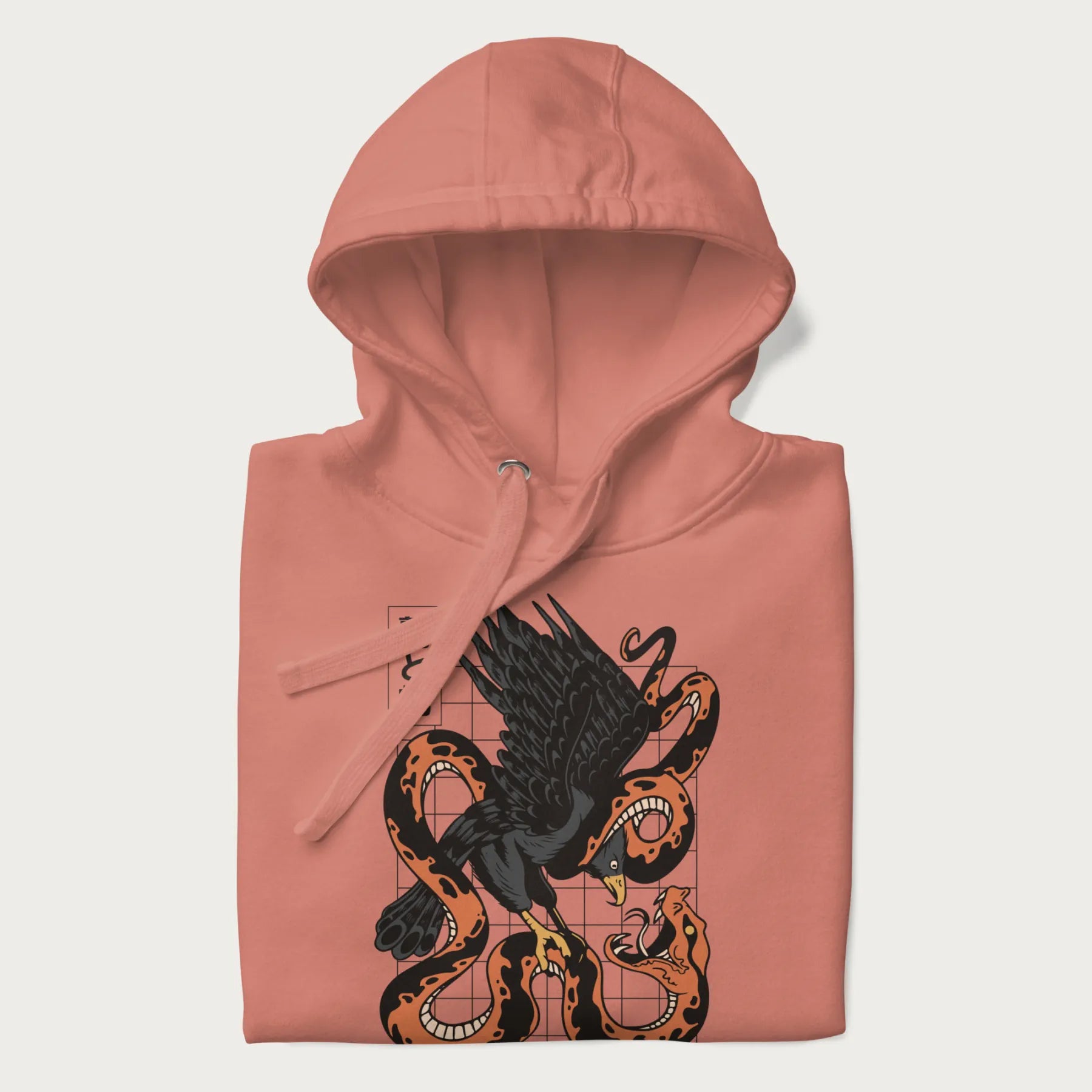 Folded light pink hoodie with Japanese text and a graphic of an eagle battling a snake, with the text 'Tokyo Japan' underneath.