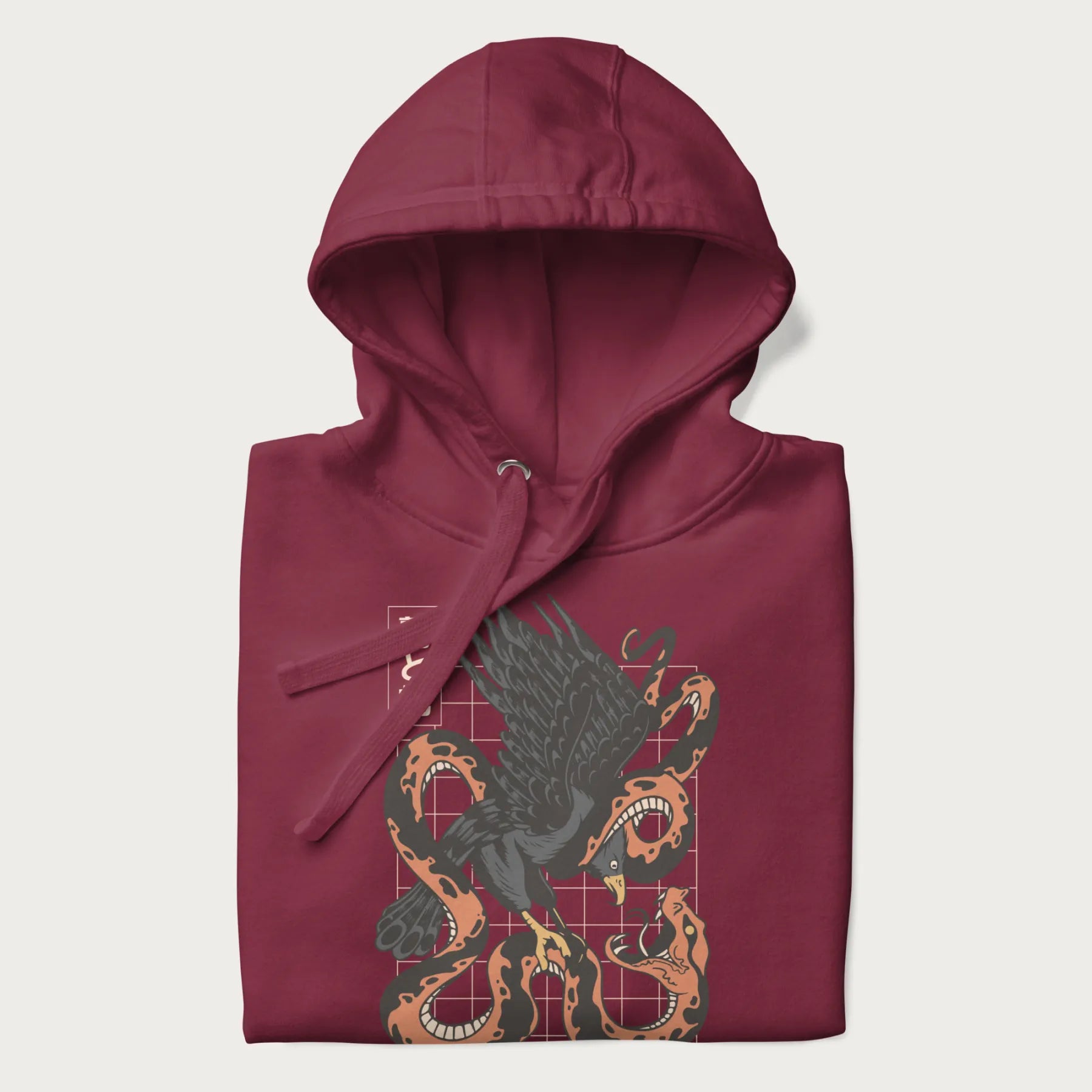 Folded maroon hoodie with Japanese text and a graphic of an eagle battling a snake, with the text 'Tokyo Japan' underneath.