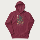 Maroon hoodie with Japanese text and a graphic of an eagle battling a snake, with the text 'Tokyo Japan' underneath.