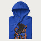 Folded royal blue hoodie with Japanese text and a graphic of an eagle battling a snake, with the text 'Tokyo Japan' underneath.