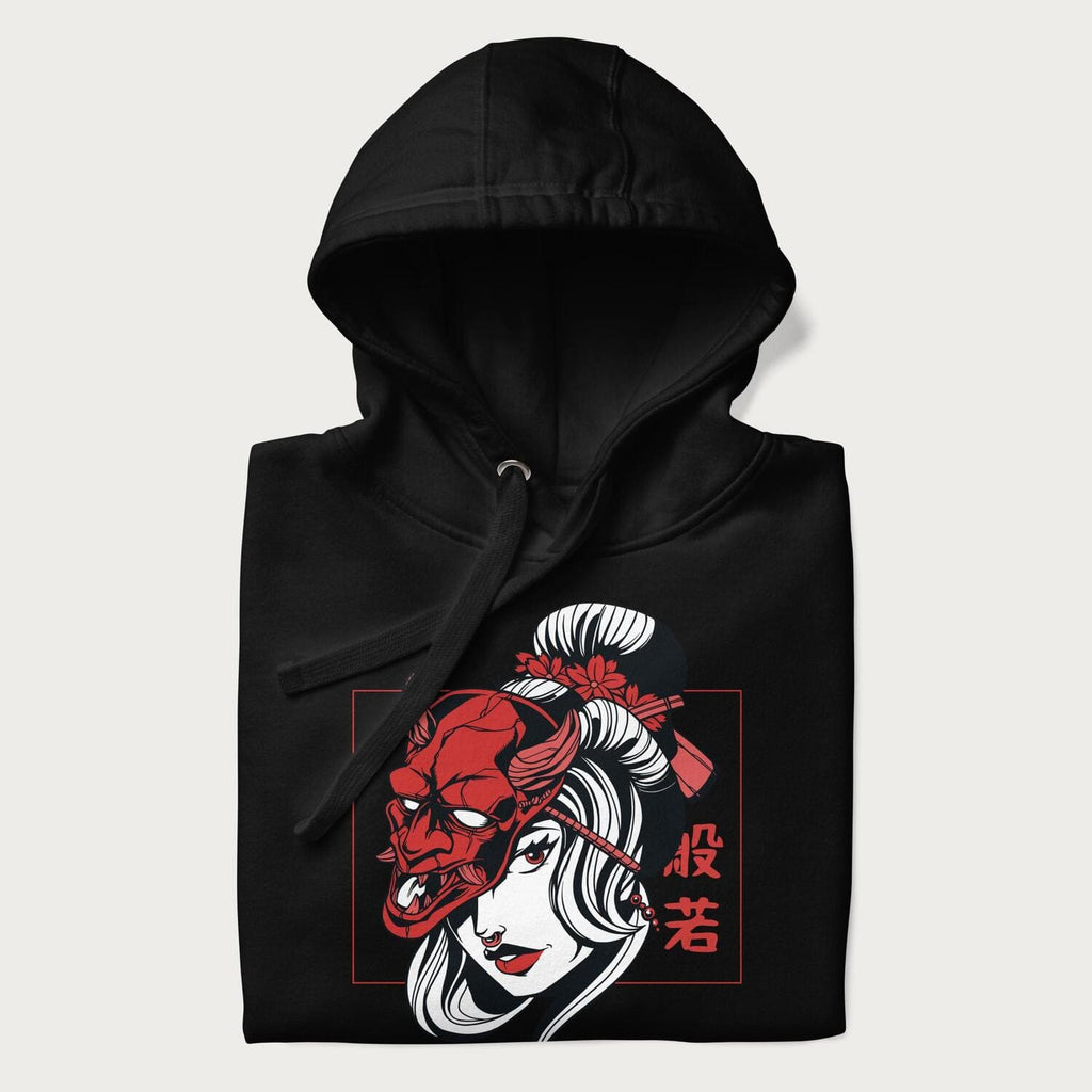 Folded black hoodie with a japanese geisha and hannya mask graphic.