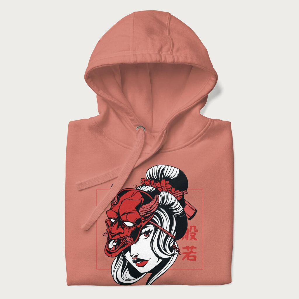 Neatly folded Japanese hoodie in a dusty rose colorway with a graphic of a geisha wearing a hannya mask.