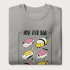 Folded light grey sweatshirt with Japanese text and graphic of cats disguised as sushi.