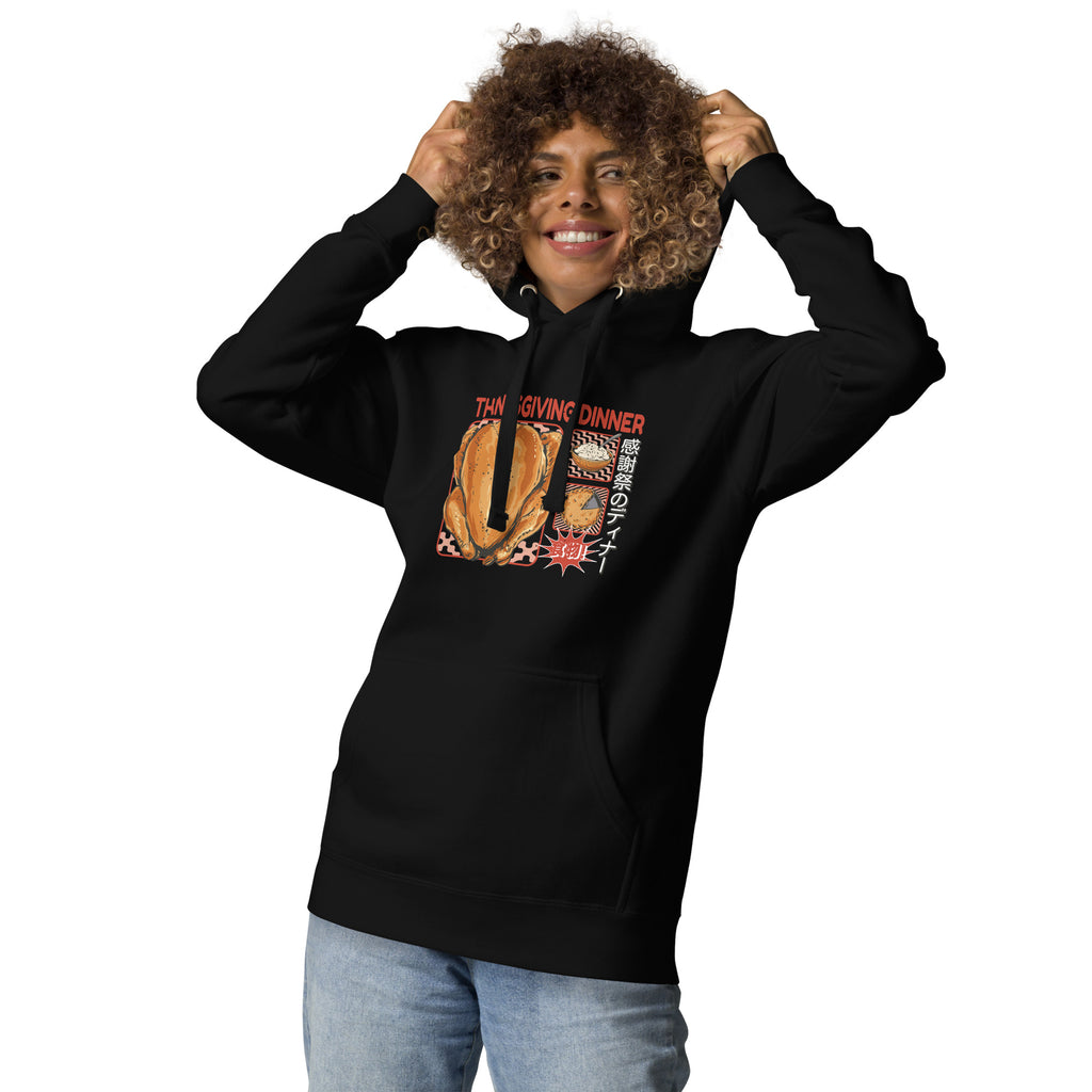 Woman wearing a Japanese Thanksgiving hoodie in Black colorway featuring a graphic print of roast chicken, Japanese potato salad, and an apple pie.
