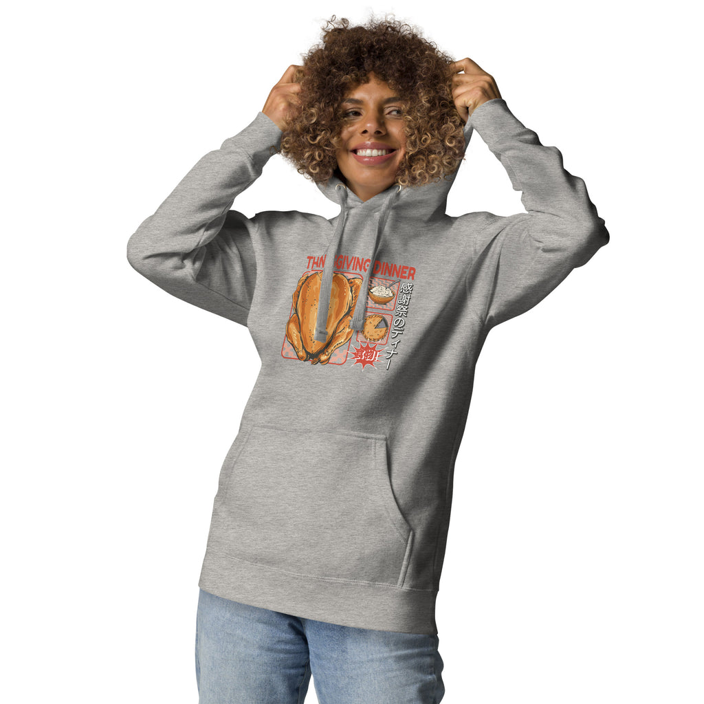 Woman wearing a Japanese Thanksgiving hoodie in Carbon Grey colorway featuring a graphic print of roast chicken, Japanese potato salad, and an apple pie.