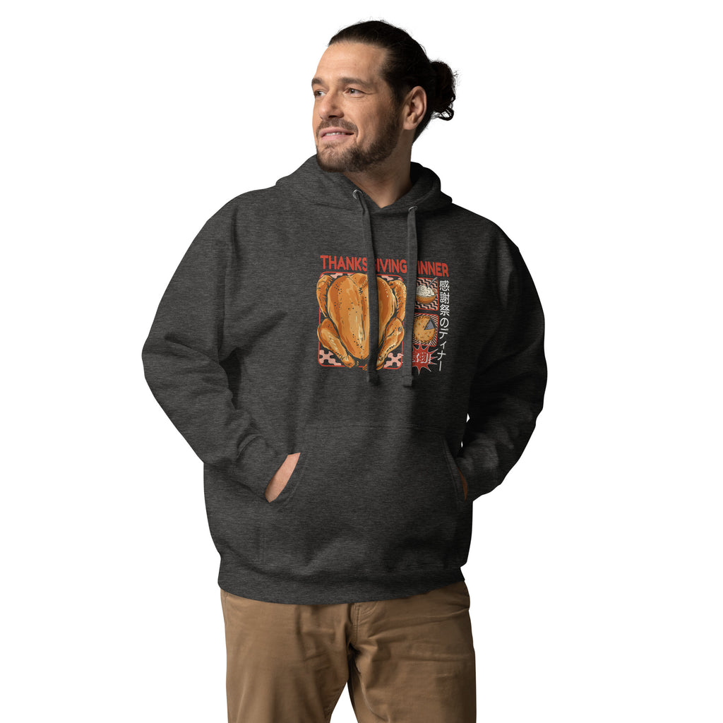 Man wearing a Japanese Thanksgiving hoodie in Charcoal Heather colorway, featuring a graphic print of a roast chicken, Japanese potato salad, and an apple pie.