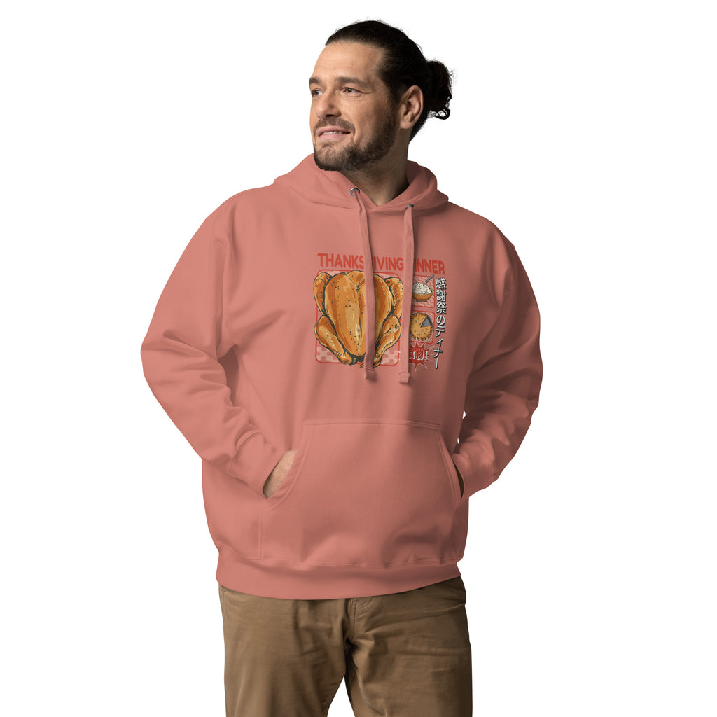 Man wearing a Japanese Thanksgiving hoodie in Dusty Rose colorway, featuring a graphic print of a roast chicken, Japanese potato salad, and an apple pie.