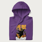 Folded purple hoodie with graphic of a 'Kaiju Cat' with helicopters and flames in a burning city.