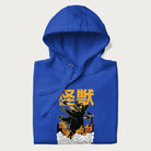 Folded royal blue hoodie with graphic of a 'Kaiju Cat' with helicopters and flames in a burning city.