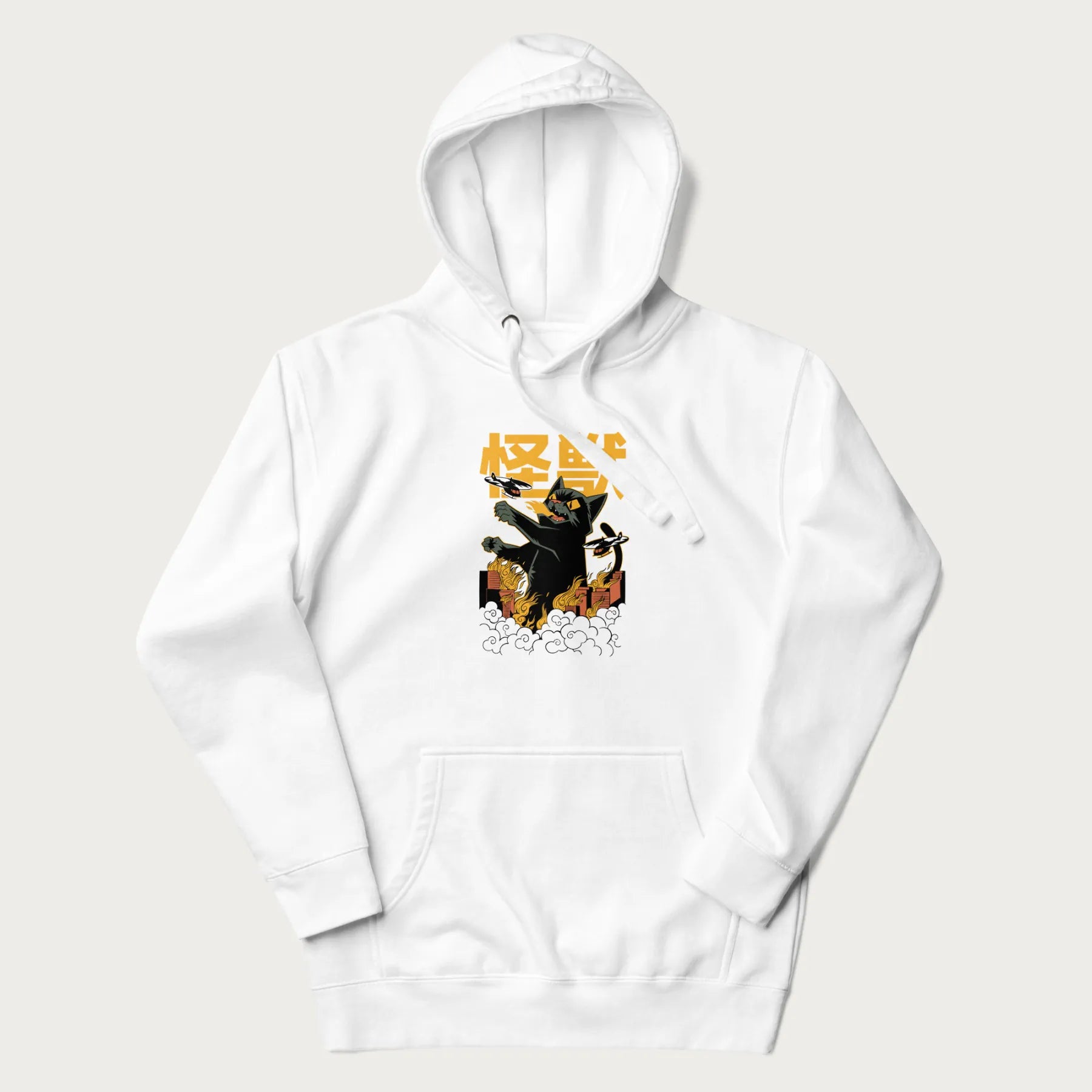 White hoodie with graphic of a 'Kaiju Cat' with helicopters and flames in a burning city.