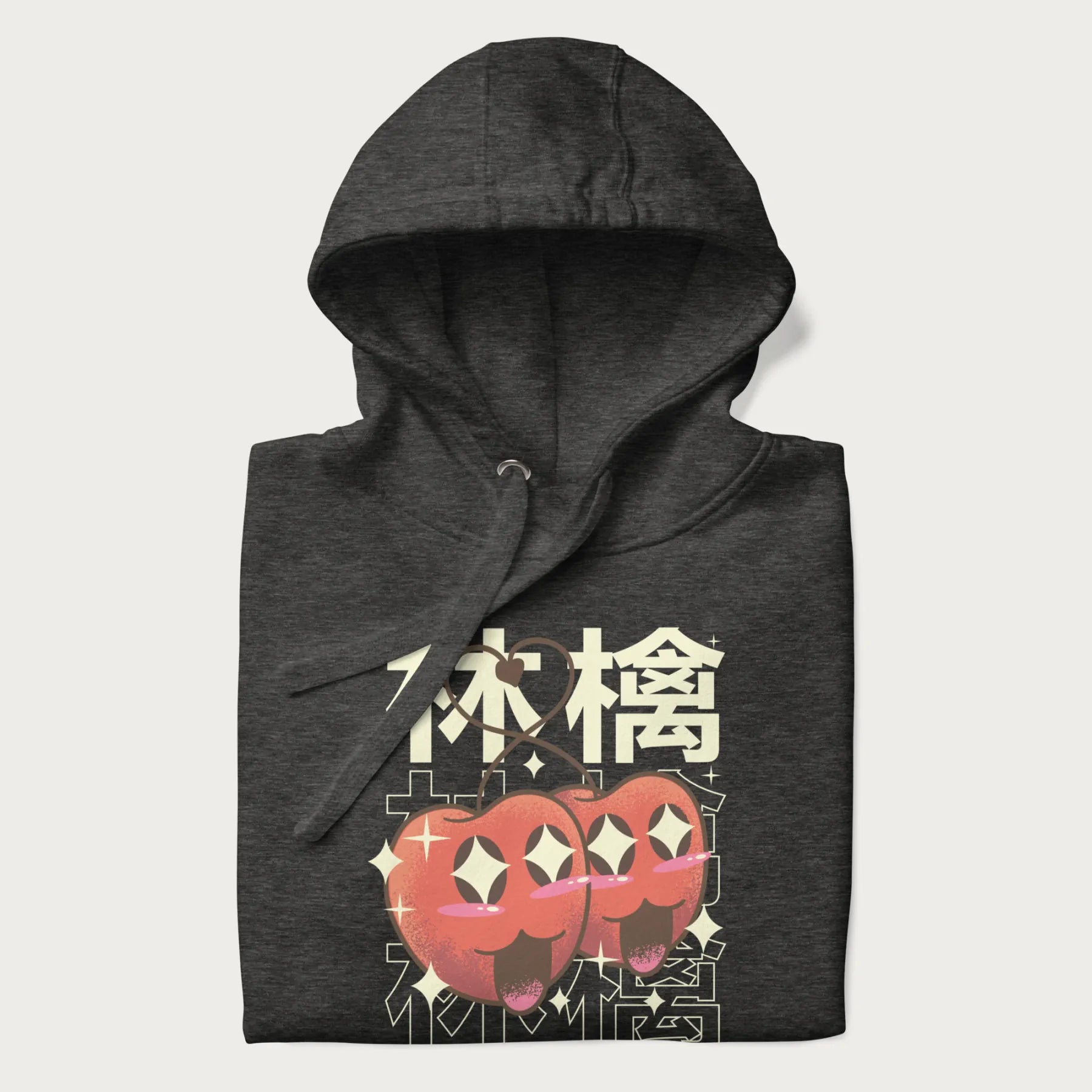 Folded dark grey hoodie with Japanese graphic of two cute apples with kawaii faces, surrounded by the Japanese text '林檎' (Apple)